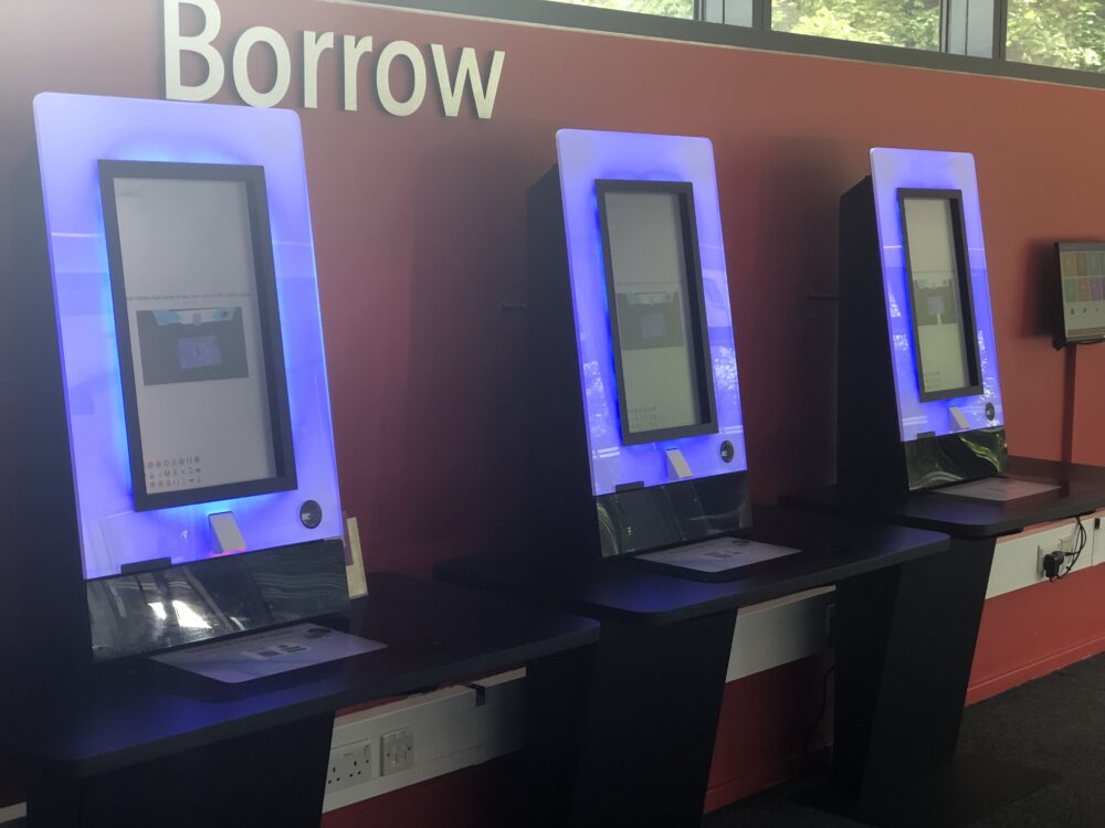 Row of self-service kiosks in library