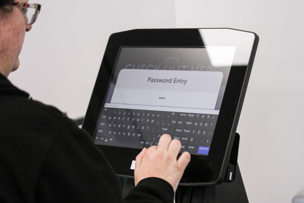 Person using self-service kiosk