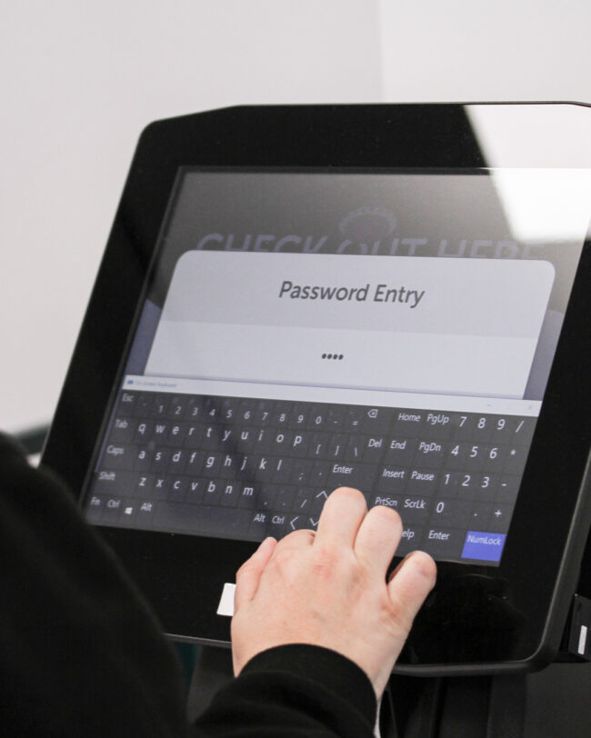 A person using the self-service library kiosk at Middlesbrough College